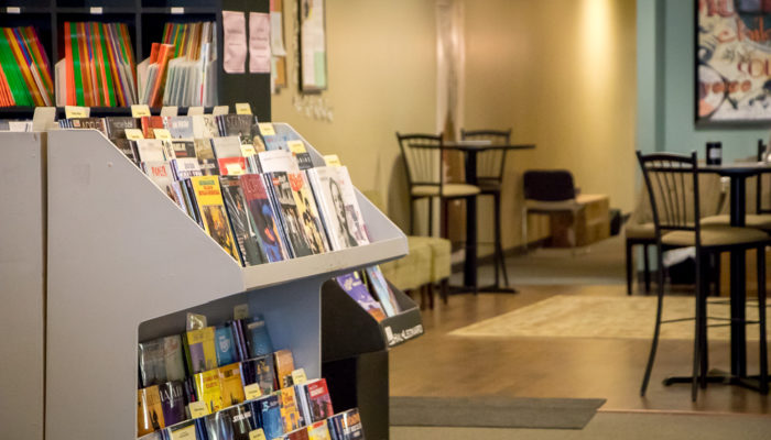 Display of printed music in front of open room.