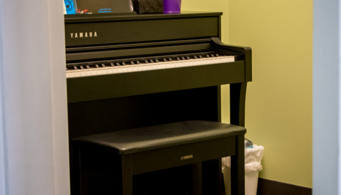 Music lesson studio with Yamaha piano.