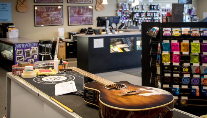 An acoustic guitar being repaired.