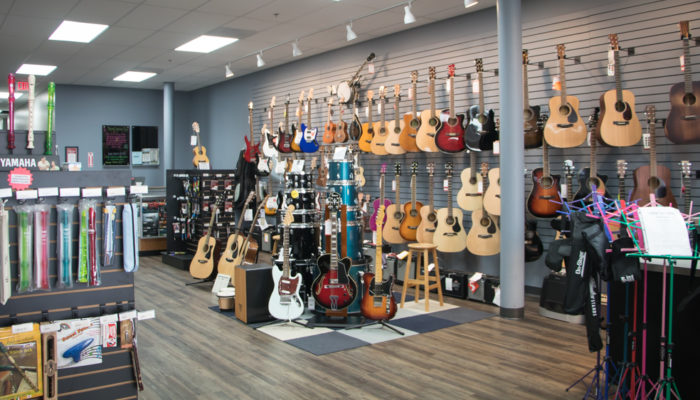 Display of acoustic and electric guitars.