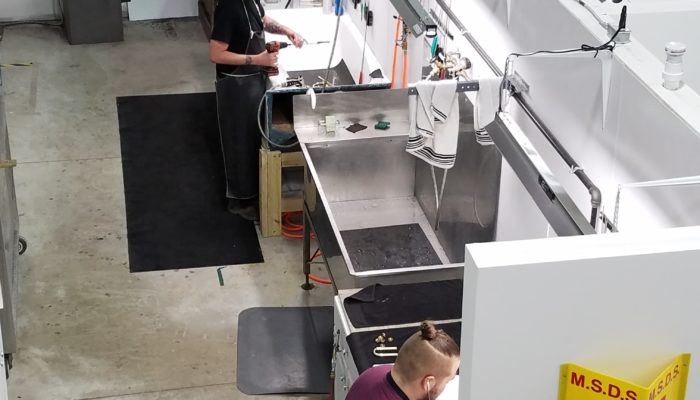 Overhead view of brass cleaning area in repair shop.