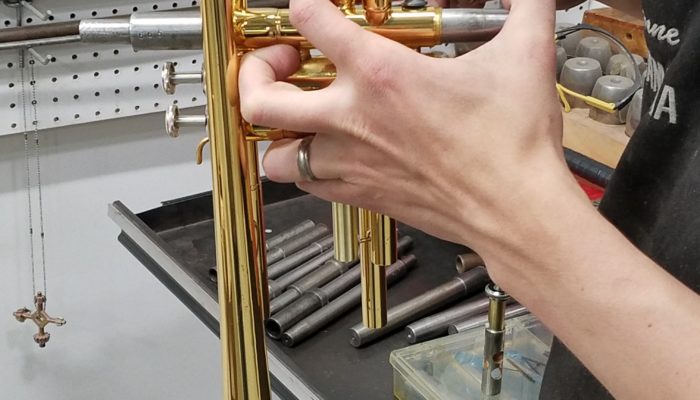 Brass trumpet in the process of having its valves repaired.