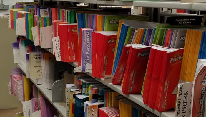 Shelves showing piano methods.