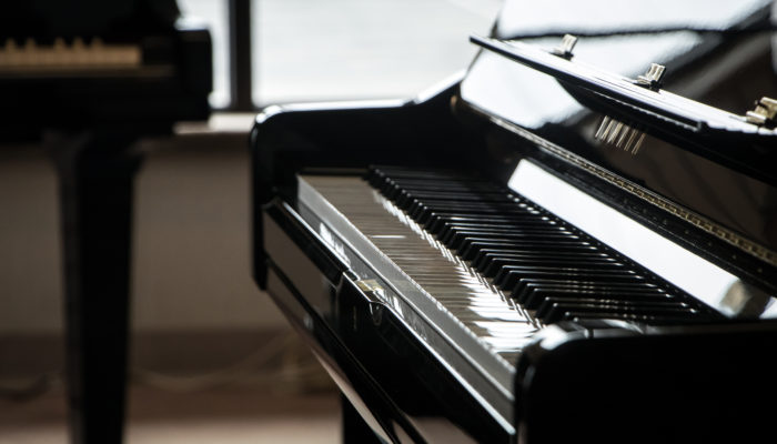 Black Yamaha grand piano.