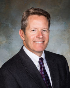 Professional photo of Joel Menchey, company president.