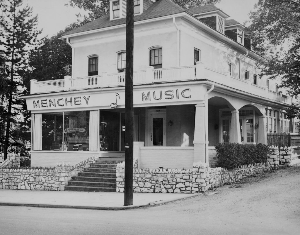 White house with porch that was the original location of Menchey Music.