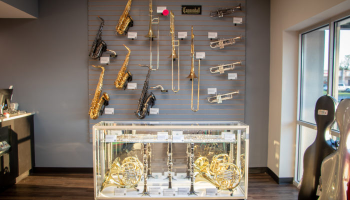 Display case an wall display of band instruments.