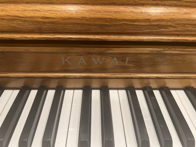 kawai oak 43 inch console piano front label view 1