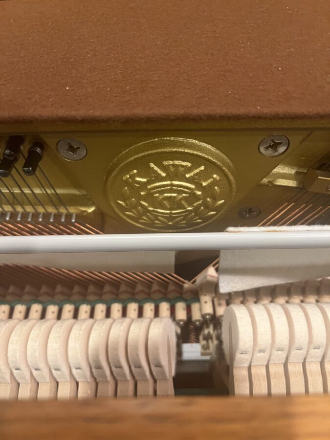 kawai oak 43 inch console piano inside emblem view 1