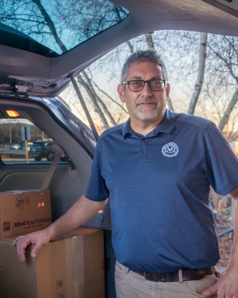 Photo of ed rep Paul Murr standing by his van.