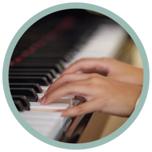 Closeup of a person's hands playing the piano.