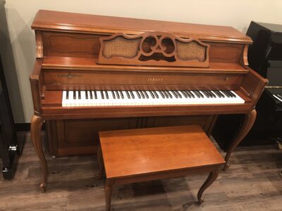 Front and open view of a Yamaha M405 cherry upright with matching bench.