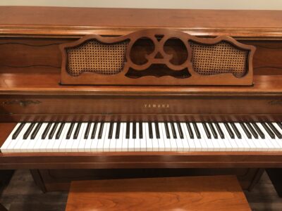 Closer front view of a Yamaha M405 cherry upright, to show the Queen Anne style music stand.