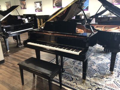Front view of a Yamaha GC2, 5'8" grand piano with raised lid.
