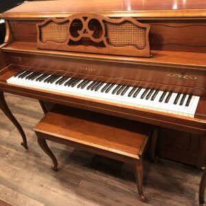 Front view with matching bench of a Yamaha M405 cherry console piano(#108632)