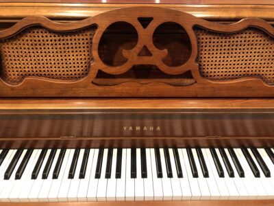 The music stand and keys of a Yamaha M405 cherry console piano(#108632)