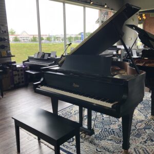 The front view of a Boston model GP163II in sating ebony with matching bench.