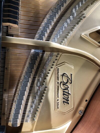 The internal plaque name of a Boston GP163II satin ebony grand.