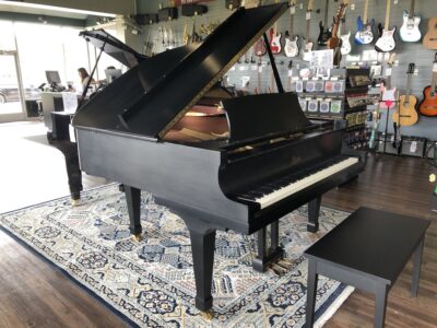 A side view of a fully open Boston GP163II satin ebony grand.