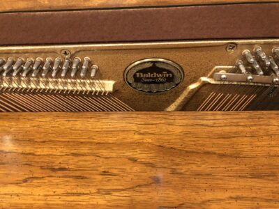 The main logo inside the Baldwin, model 1024, #1376388 pecan upright.