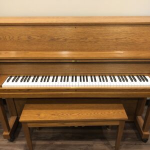 The direct front view of a Yamaha P22 in Oak, #T174979 and matching bench.