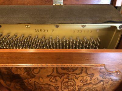 The serial and model number of the Yamaha, Model M500P in cherry, #233143 from 1998 with matching bench.