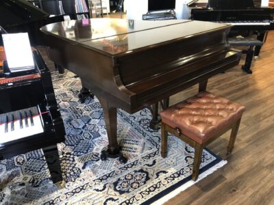 The front, closed view of a Steinway - Model “M” (brown mahogany) – 5’7” Grand Piano.