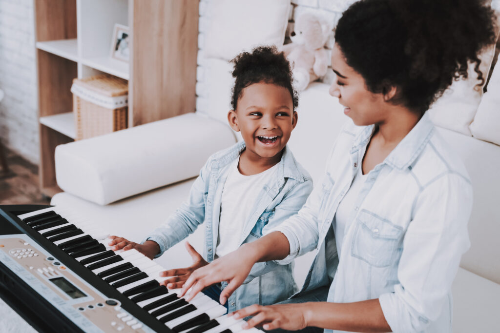 Mom and daughter practicing piano together