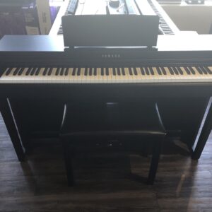 The front view with matching bench of the Yamaha Clavinova CLP625B, UCYX01042.