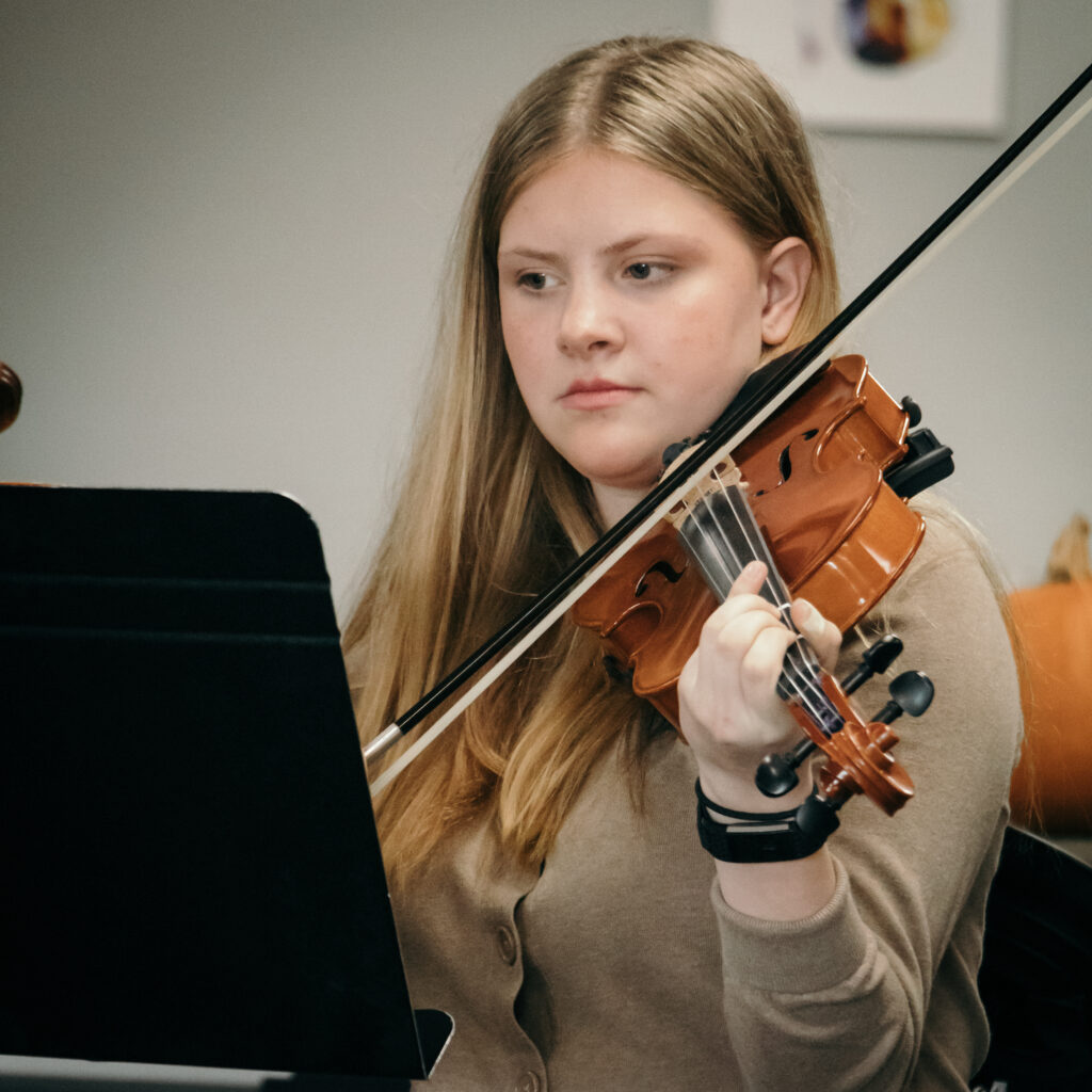 Student renting a school band instrument at Menchey Music