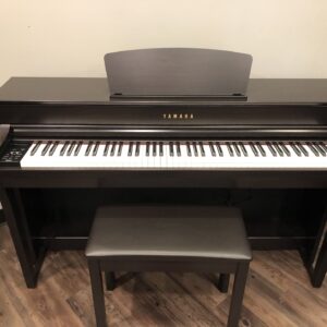 The front view of the Yamaha_Clavinova_CLP735R_UCAZ01143 with matching bench.