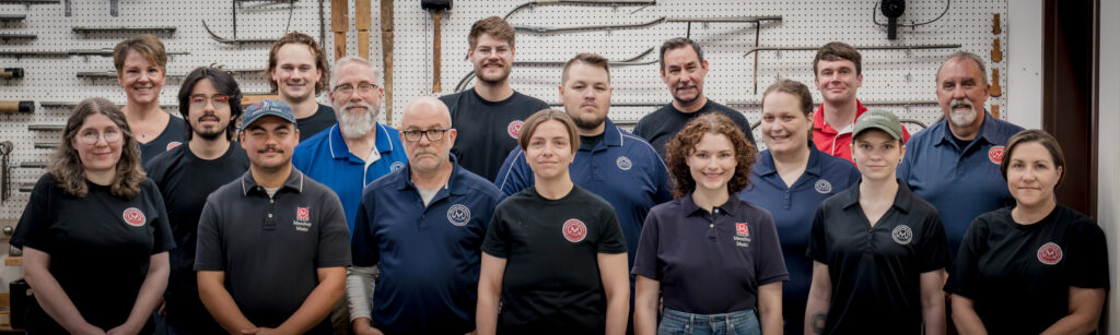 The Menchey Music repair shop team, 2026