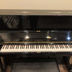 The front view of the Yamaha_U1F_PE_5112066 with matching bench.
