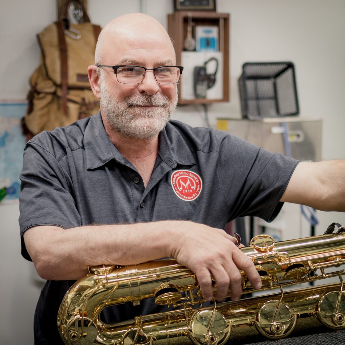 Photo of Jared, a Menchey Music woodwind tech, with a saxophone